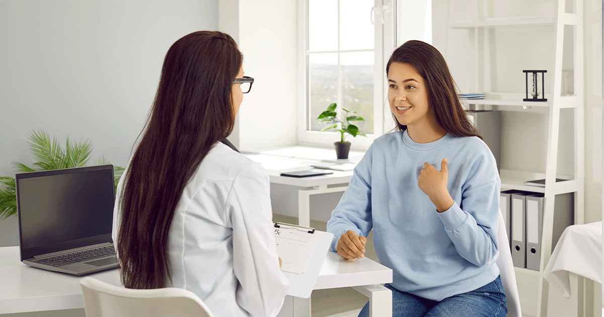 Woman speaking with a healthcare professional about pregnancy options and emotional well-being.